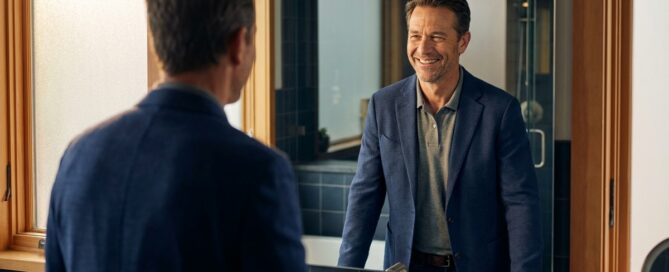 Confident man looking in mirror representing best hair loss treatment for male pattern baldness results