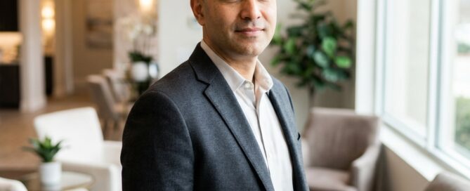 Confident man with shaved head in a modern medical setting, representing scalp micropigmentation for hair transplant scars.