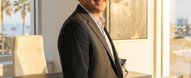 Confident hair transplant Boca Raton Florida specialist standing in a modern, sunlit medical office