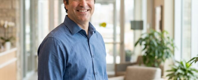 Confident man with restored hair standing in a modern clinic, representing non surgical hair restoration options for men 2026