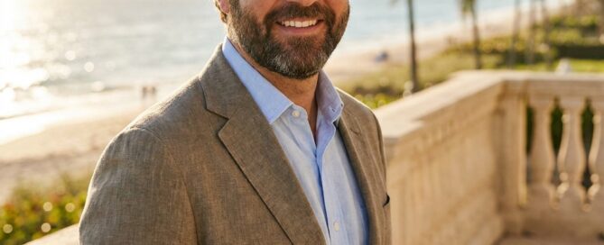 Confident man with restored hair on Palm Beach terrace, representing hair restoration options in Palm Beach County Florida