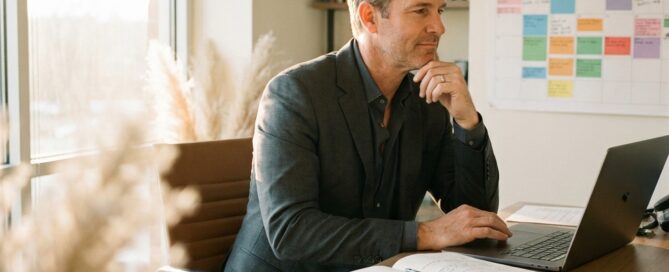 Professional man confidently working at office desk, representing hair transplant same day return to work procedure planning
